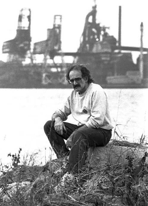 Activist Ric Coronado is shown at the Detroit River, with Zug Island in the background, on Oct. 17, 1990. Both were fighting points in his decades-long battle for the health of the local environment. RANDY MOORE / WINDSOR STAR