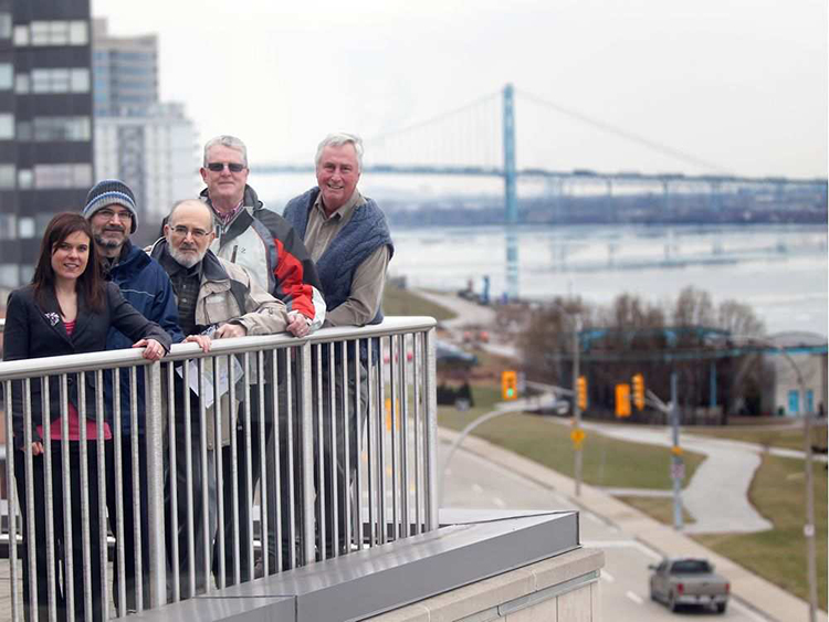 Natalie Green, left, Derek Coronado, Ric Coronado, Ian Naisbitt and Doug Haffner look out to the Detroit River following a press conference on the Canadian Cleanup Remedial Action Plan Milestone, at the Art Gallery of Windsor on Jan. 25, 2012. JASON KRYK / WINDSOR STAR